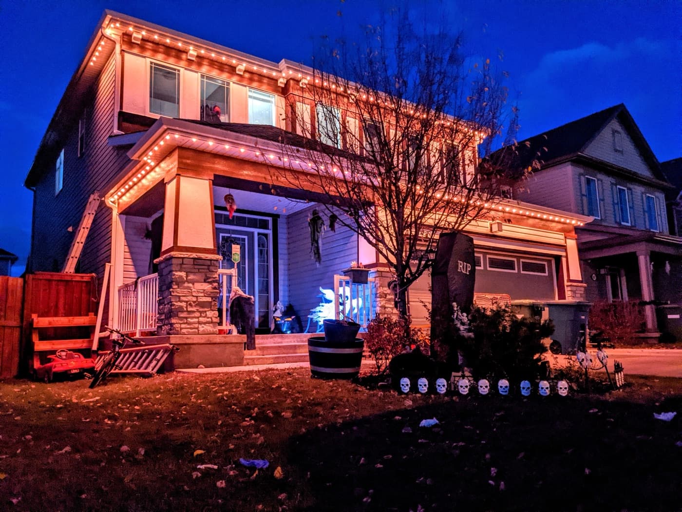 Halloween orange permanent lighting on a two-storey home